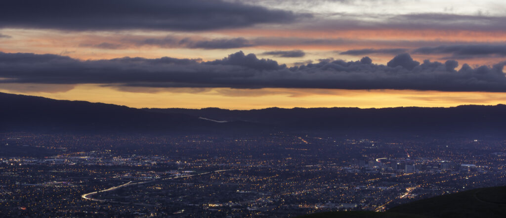 Storm clouds make for a dramatic sunset over sprawling San Jose.