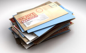 A pile of envelopes with delivery stamps saying balance overdue symbolizing bills and debt on an isolated white background for a San Jose car accident attorney helping with San Jose car accidents to review