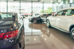 new cars in showroom interior blurred abstract background with clients who are working with the insurance company and leasing company