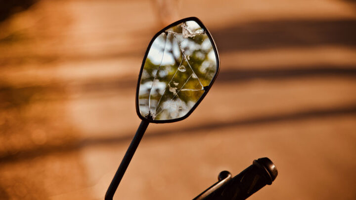 A broken looking mirror of a bike isolated unique photo